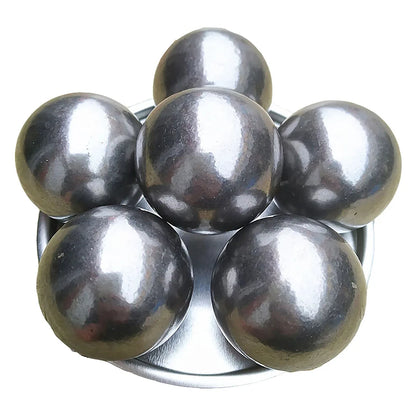 Six solid pétanque balls made of high-quality metal, arranged on a metal plate, showcasing their excellent craftsmanship and durability.