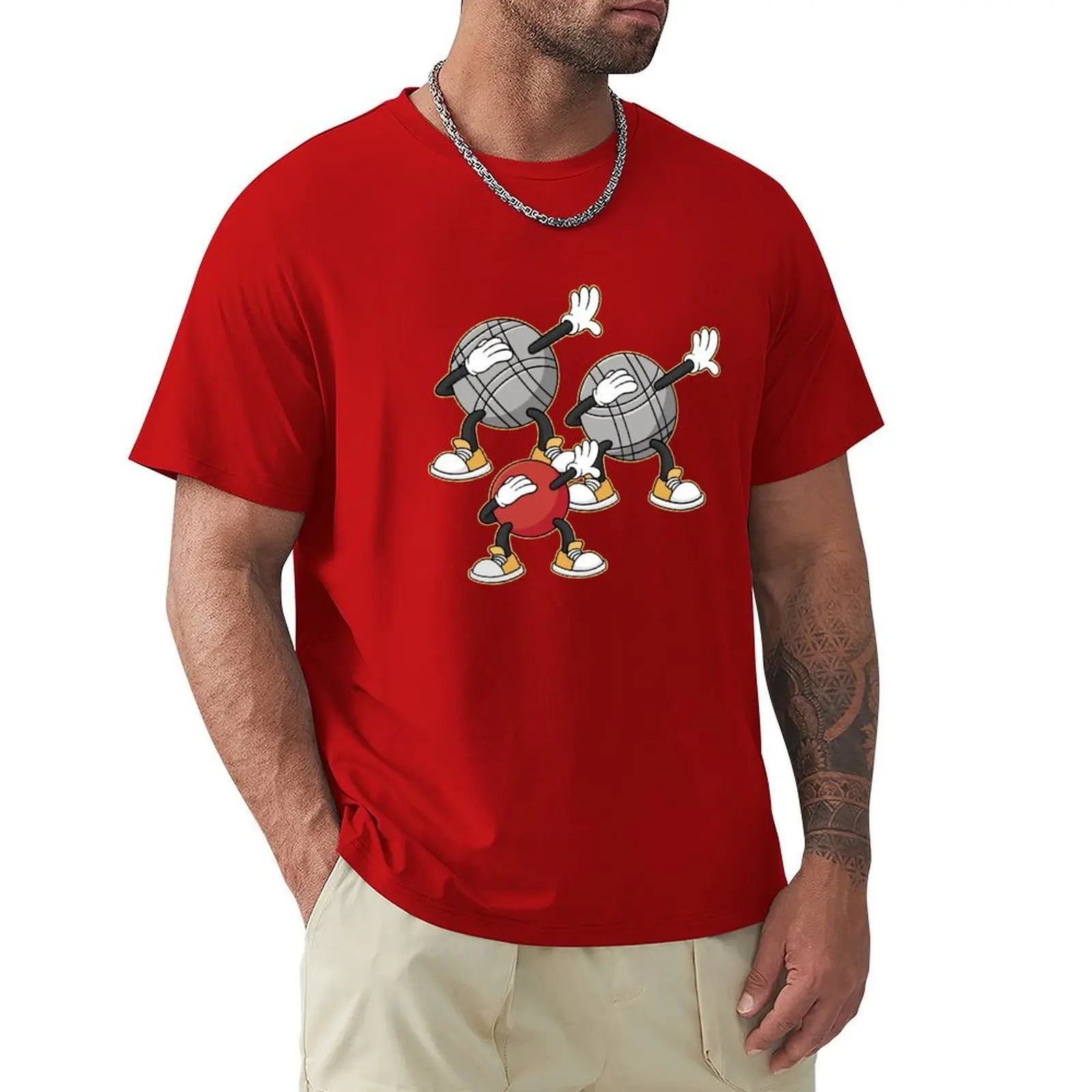 Red T-shirt nouvelle édition featuring cartoon pétanque balls design worn by a man.