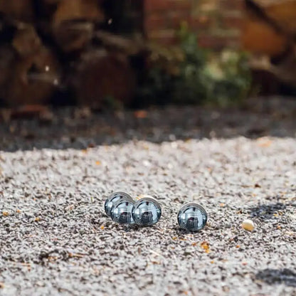 Elegant Boule de pétanque set on gravel surface, reflecting quality craftsmanship.